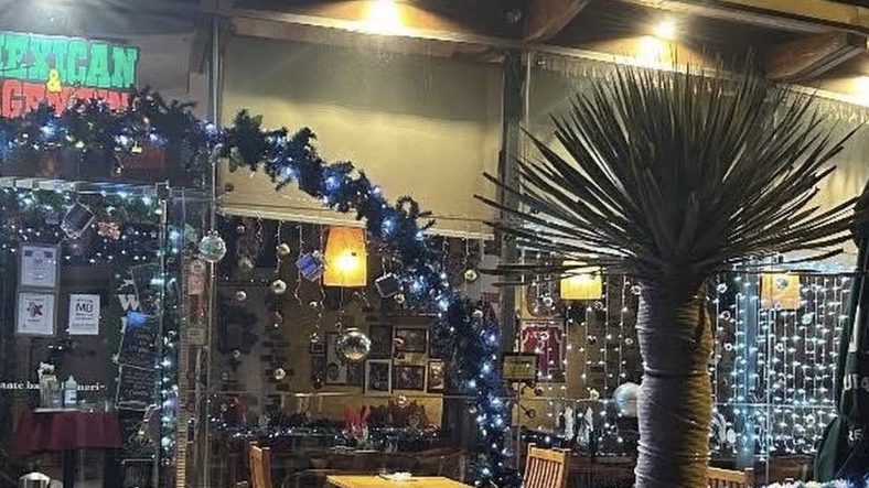 The covered terrace at the front of El Mexicano in Funchal, hung with fairy lights, under a sign reading Mexican and Argentinian.