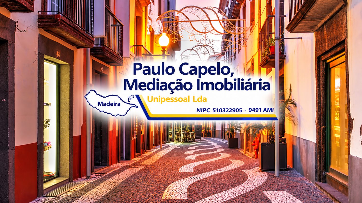 The Paulo Capelo Mediação Imobiliária banner: the agency name and an outline of Madeira over a lamplit pedestrian shopping street in Funchal